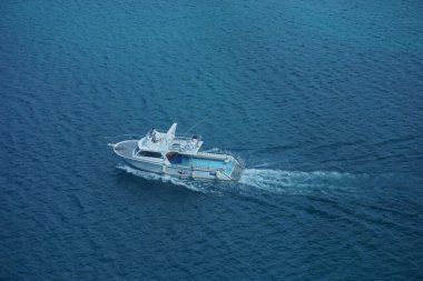 Okyanusta yüksek hızla giden bir balıkçı teknesinin havadan görüntüsü..  