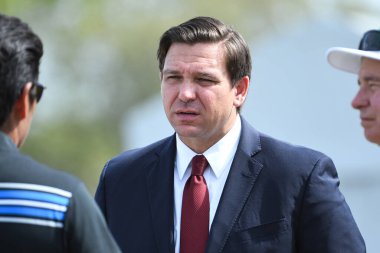 Florida Governer Ron DeSantis speaking with players during the opening event at the 2020 Arnold Palmer Invitational at Bay Hill in Orlando Florida on Wednesday March 4, 2020.  clipart