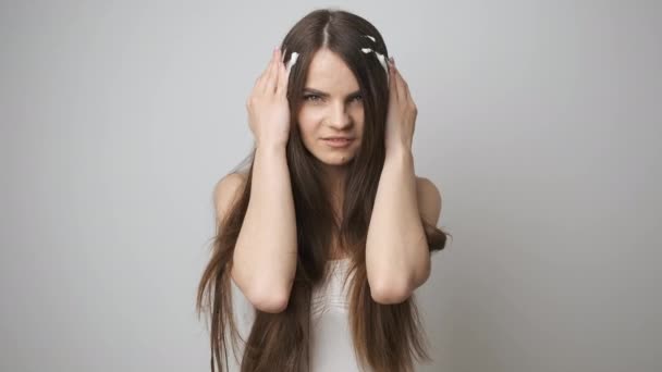 Brunette applique de la mousse sur les cheveux dans la salle de bain. La fille fait des traitements de spa pour elle-même — Video