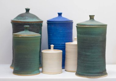 El yapımı kil çömlek beyaz bir rafa ayarla