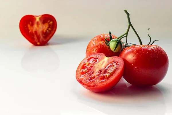 handful of tomatoes with chopped and in the shape of a heart-shaped tomato in the removal on a white background