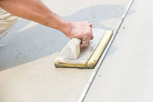 Plaster concrete floor with workers on construction sites.