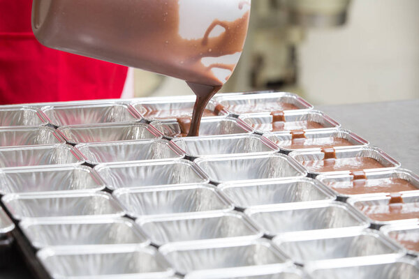 Thai bakery method baking chocolate brownie cake in pan