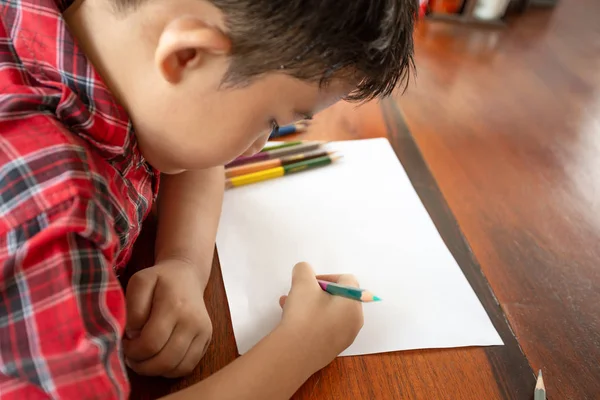 Asyalı küçük çocuk beyaz kağıda yazı renk kalem kullanın