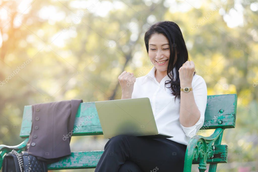 Asian beautiful business woman work relaxation with laptop in park