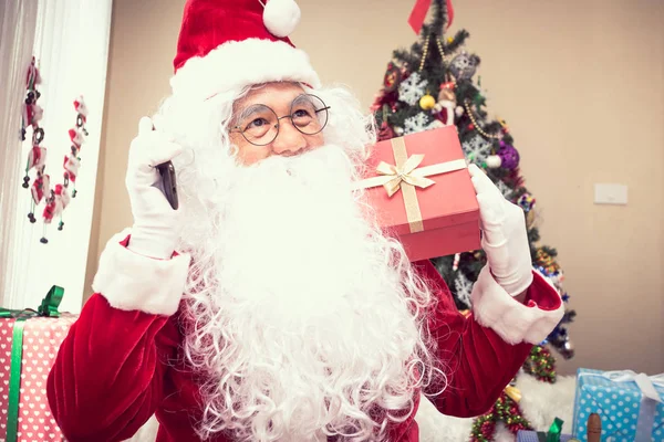 Santa Claus holds gift in hand, there is money in the gift,christmas concept