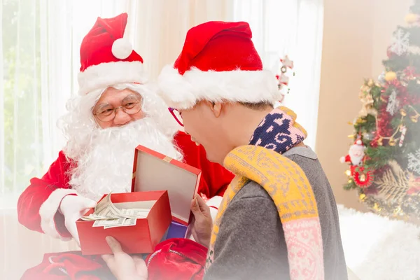 Santa claus gives gift to man Christmas eve ,Christmas concept