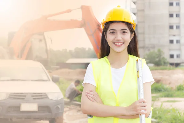 Beautiful woman, Asian building, consrtuction concept - smiling businesswoman