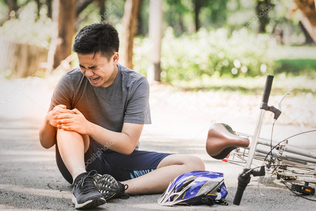 Sport men cyclist riding mountain bike spin down and fall injured. Sport life concept in the summer