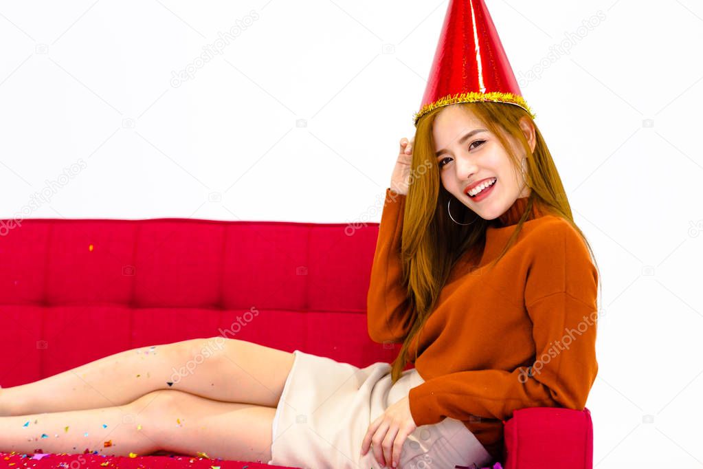 Portrait Asian women  sitting on a red sofa,Holliday party concept