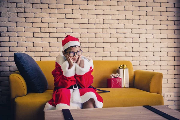 Merry Christmas Little Boy Sit Wait Gift Box Yellow Sofa 图库图片