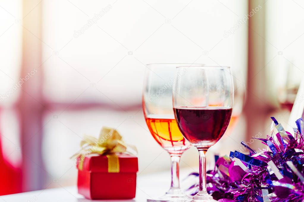 Two wineglass and red gift box setting object party on teble