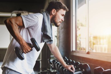 Closeup men healthy holding dumbbell workout and building body at gym fitness clipart