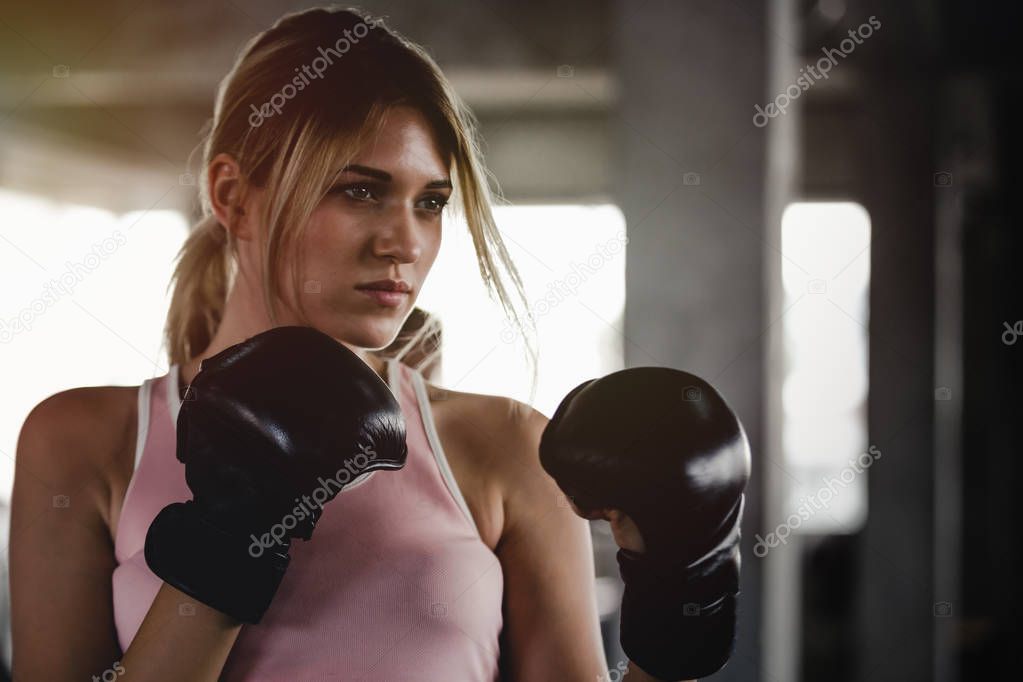 Portrait sporty girl beautiful woman with the back boxing gloves