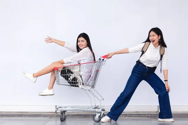 아시아 의 젊은 소녀 앉아 에 쇼핑 카트 용 마케팅 개념 — 스톡 사진