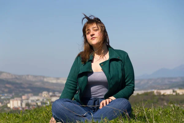 Beautiful Curvy Girl Green Jacket Jeans Sits Lotus Position Smiles — Stock Photo, Image