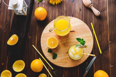 Cam buz küpleri ve portakal ahşap masa üzerinde taze sıkılmış portakal suyu. Sonbahar rahat rustik ruh natürmort