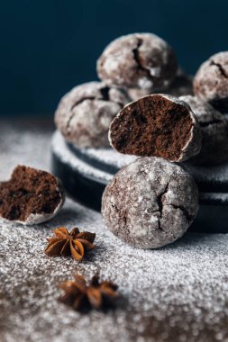 Tahta zemin üzerinde pudra şekerli birkaç mermer kahverengi kurabiye.