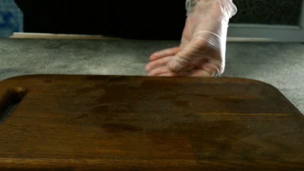 Chef with his hands cuts carcass of raw chicken broiler into pieces with kitchen knife. And cut part of chicken breast. Close-up. — Stock Video