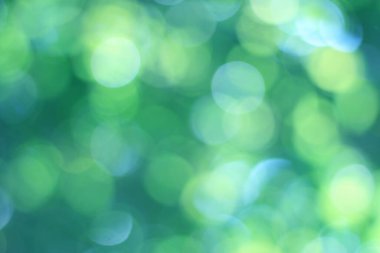 Soyut bokeh, doğal yeşil ve mavi arkaplan, yaz boyunca güzel bulanık, ağaçtaki yapraklardan alınan mavi-yeşil bir bokeh ve sarı-mavi bir ışık var.