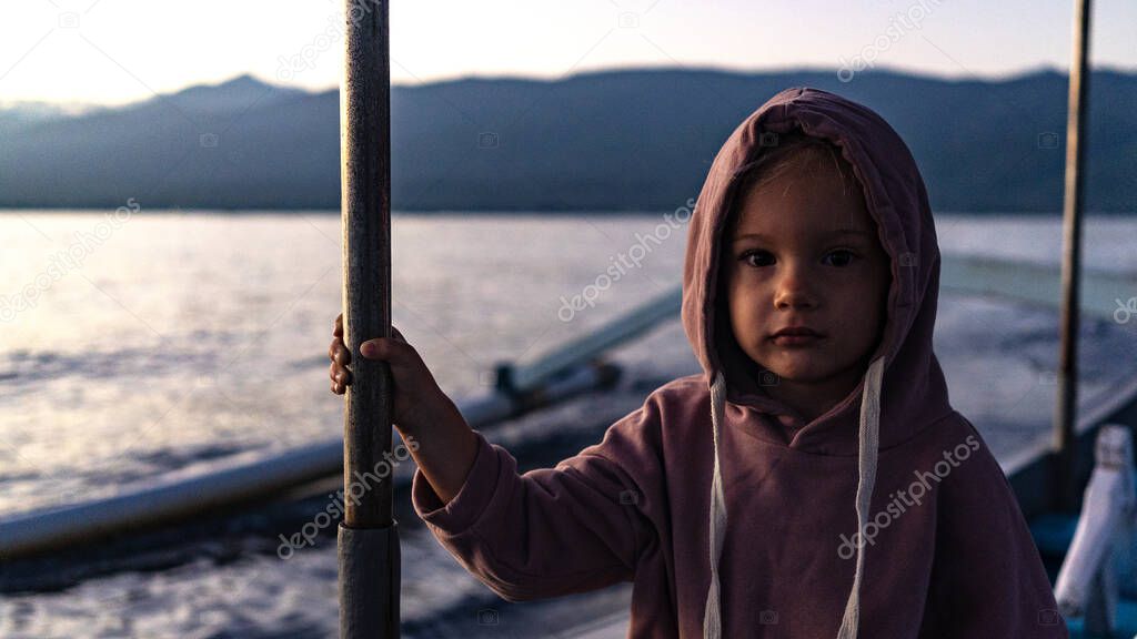 portrait of a cute little girl with on the boat