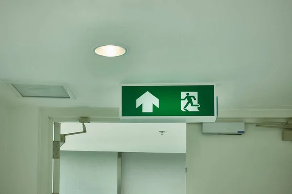 Fire exit sign in building, Emergency fire exit in office.