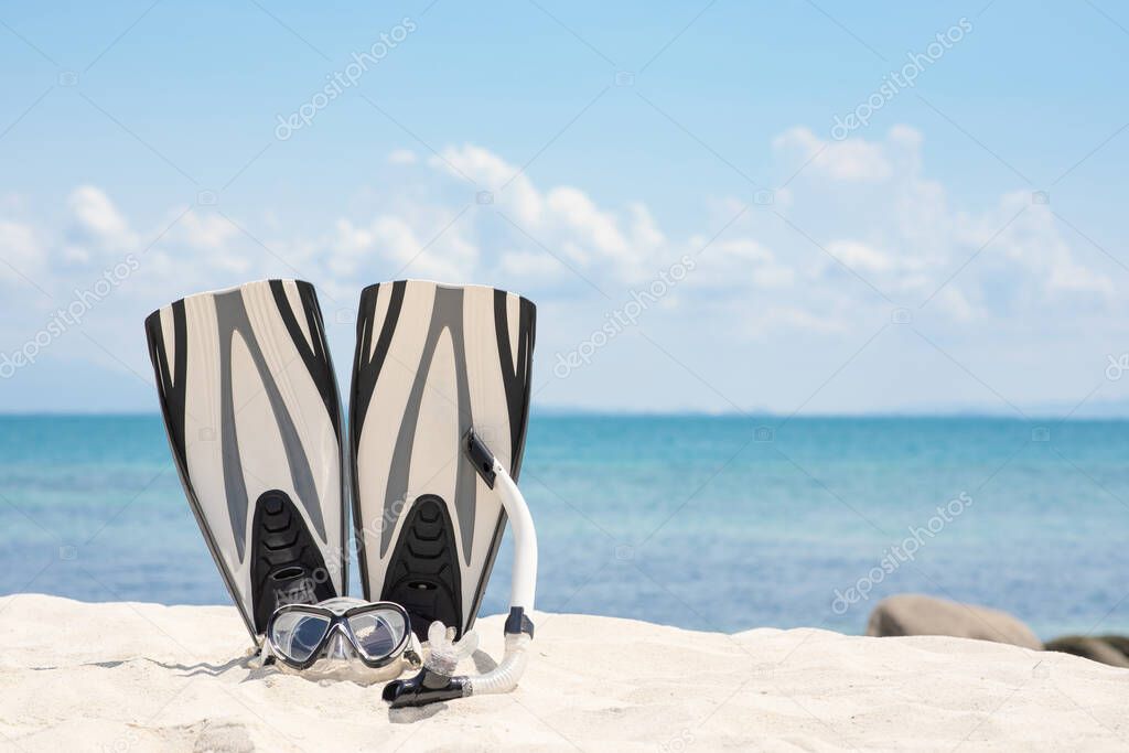 White Snorkeling mask and fins on the destination vacation travel tropical on the beach in Thailand,Summer Vacations Concept