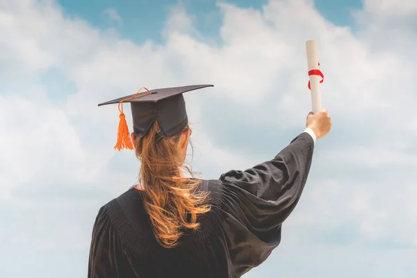 Graduate Woman Cap Dress Celebrating Certificate Her Hand Blue Sky — Φωτογραφία Αρχείου