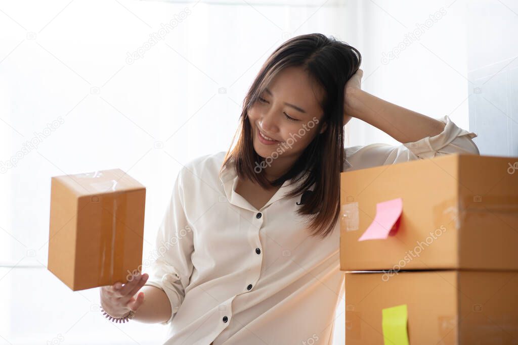 SME entrepreneur of Young Asian women working with laptop for Online shopping at home,Cheerful and Happy with box for packaging in home,Own Business Start up for Business Online and Online shopping 