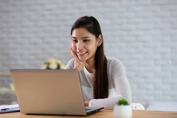 Beautiful Attractive Asian indian woman working with computer laptop and thinking to get ideas and requirement in Business startup at home feeling so happiness,Business Startup Concept