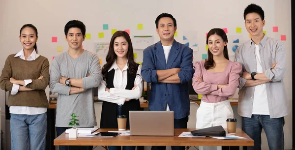 Group of Happy Asian business men leader standing smile cross arm confidence with Business team at Co-Working space,Small Business Startup Concept