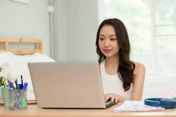 Beautiful Attractive Asian indian woman working with computer laptop and thinking to get ideas and requirement in Business startup at home feeling so happiness,Business Startup Concept