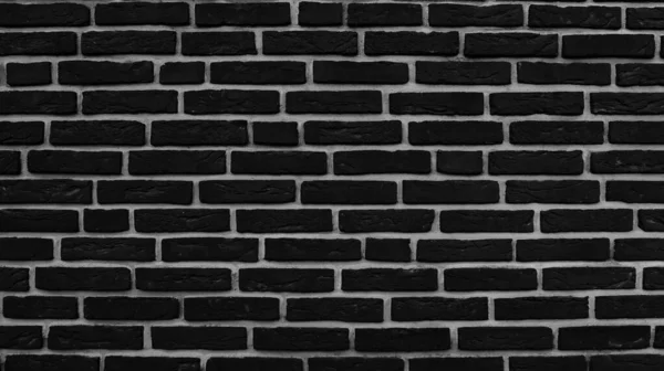 黒レンガの壁の暗い質感の背景 ストックフォト