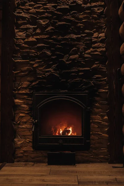 Fireplace with lit wood.Fire.Stone wall