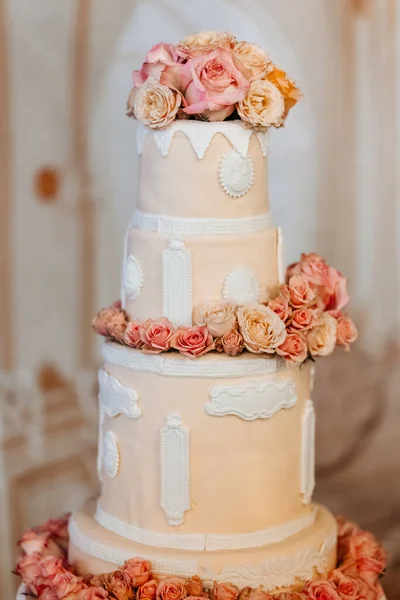 Beautiful multi-tiered wedding cake in peach tones