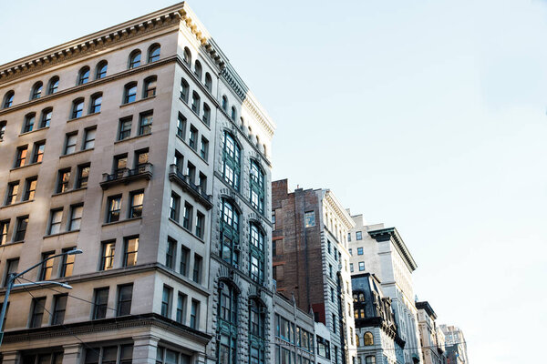 Buildings of New York City. Old architecture of Manhattan. Old fashioned buildings. Facades of New York. New York street pedestrian direction sign. Street name signs in Manhattan. Empty streets of New York City.