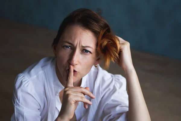 Una chica, una mujer cubre su cara con sus manos Imagen de archivo