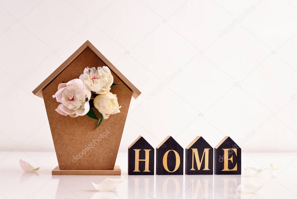 Home decor concept card template, front view of a bird house with peonies bouquet inside of it 