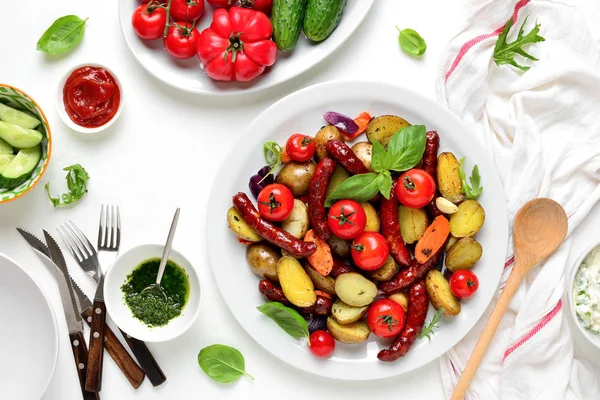 Sausages roasted with vegetables, view from above