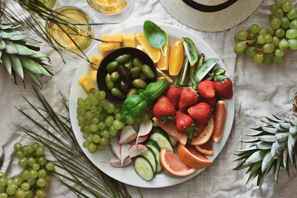 Beach summer table setting with fruits and veggies