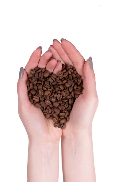 女性の手が折り畳まれ 心の形でそれらに注ぎコーヒー — ストック写真