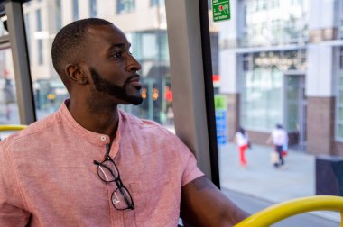 Man sitting in bus and looking through window