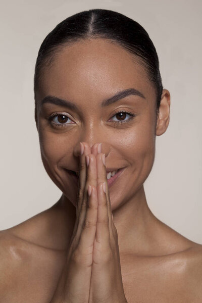 Portrait of young woman with clasped hands