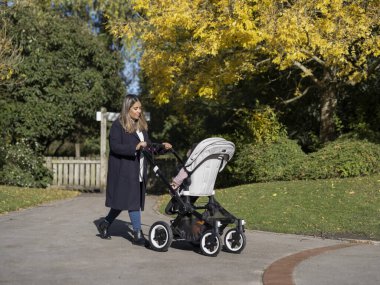 Mother walking with daughter in stroller