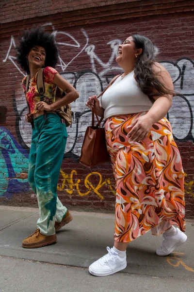 Two women on sidewalk