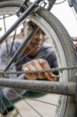 Close-up of woman adjusting bicycle tire air valve