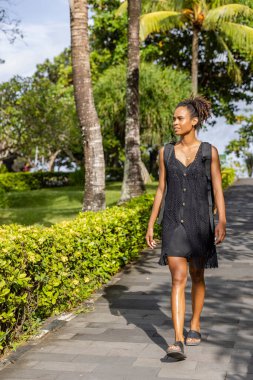 Bali, Indonesia, Female tourist walking on sunny day