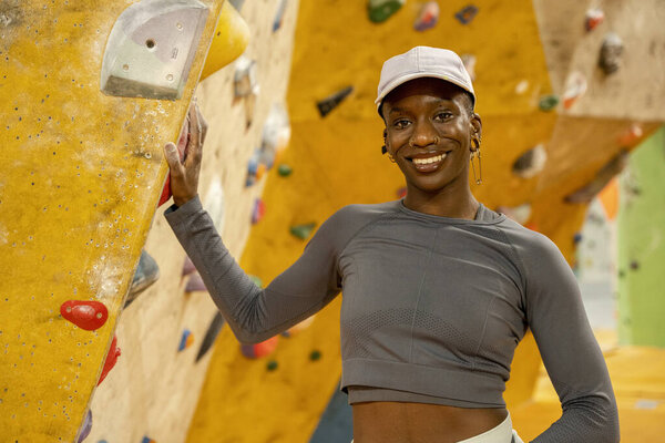 Portrait of smiling Woman at climbing wall