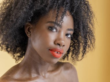 Studio portrait of pensive woman with curly hair