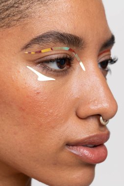 Close-up of woman with golden foil make-up